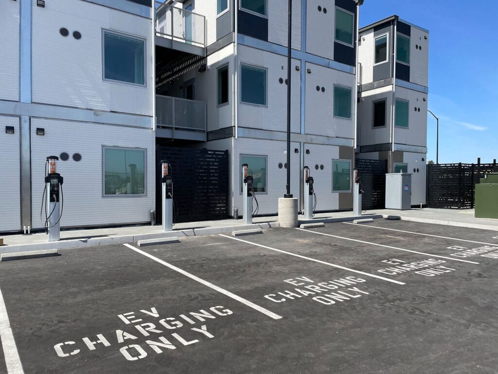 EV charging only parking spaces with multiple Level 2 chargers at a multi-unit housing complex